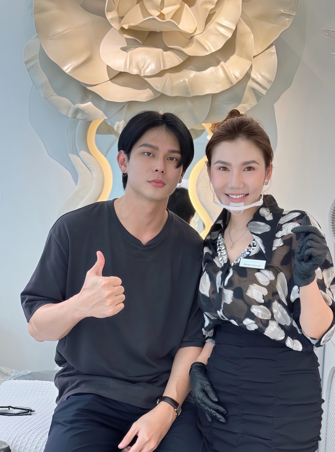 Male client giving a thumbs up beside Master Coco Le after his brow treatment at COCO BROW Singapore